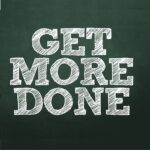 Business man pointing with the text: Get More Done
